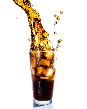 Cola drink splash with ice cube on white backgroundの写真素材