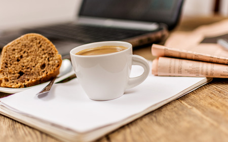 Office background with laptop coffee  dessert  notepadの写真素材