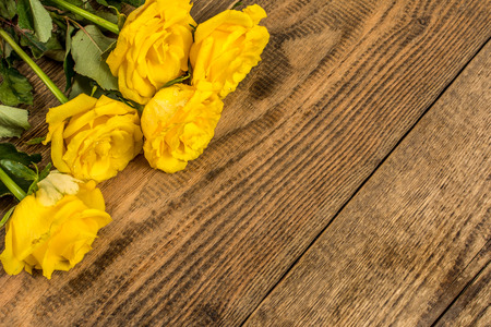 Flowers yellow roses on wood background photographyの写真素材