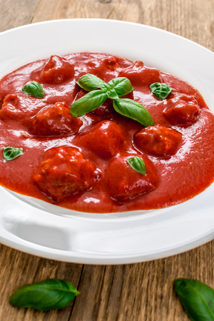 Tomato sauce with meat balls in white plateの写真素材