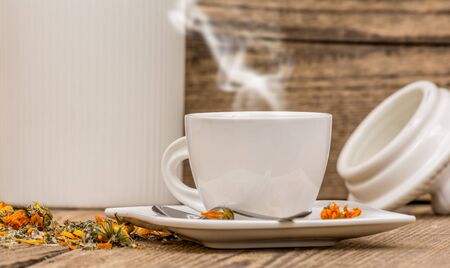White cup of herbal tea on wood backgroundの写真素材
