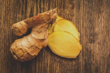 Cut of raw ginger on wood tableの写真素材