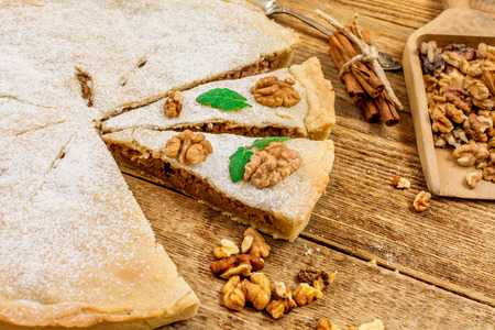 Traditional apple pie dessert with walnuts on wood tableの写真素材