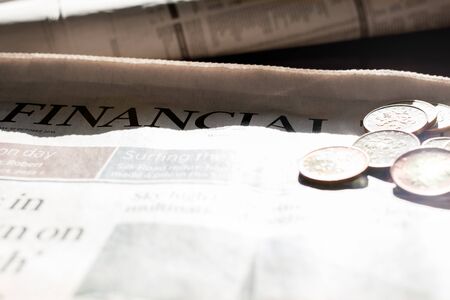 Coins and newspaper with inscription financial