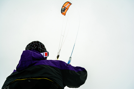 Man kite skiing on snow in windの写真素材