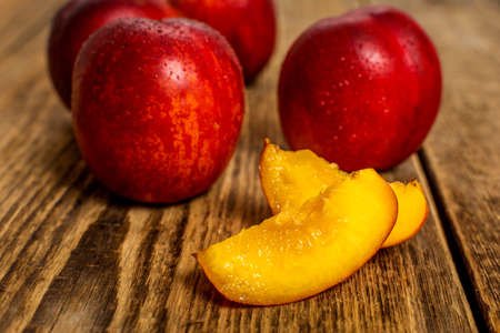 Fresh nectarine with water drops on wood tableの写真素材