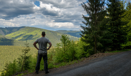 Man tanding and looking to nice  mountains Beskydy