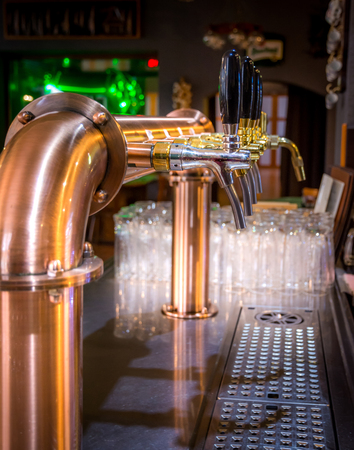 Golden chrome draught taps in a barの写真素材