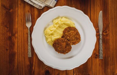 Fried minced meat with cheese and mashed potatoes on white plateの写真素材
