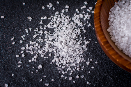 grain of salt on black stone tableの写真素材
