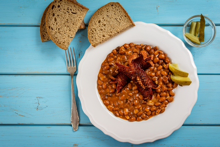 Red beans with sauce and grilled sausage on blue table top viewの写真素材