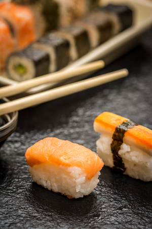 Traditional japanese sushi nigiri and chopsticks on stone deskの写真素材