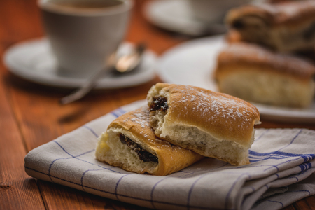 Traditional czech buns with plum jam and coffee on wood tableの写真素材