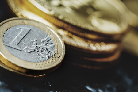Virtual currency Bitcoin and Euro coin on dark table