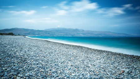 Ocean beach with turquoise water on the Crete long explosureの写真素材