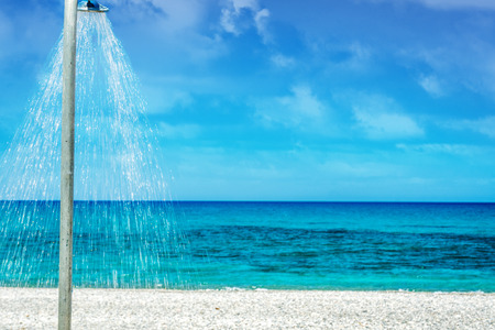 Ocean beach with shower  on the Crete in sunny dayの写真素材