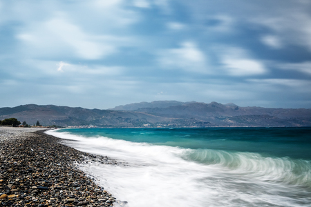 Ocean beach with turquoise water on the Crete long explosureの写真素材