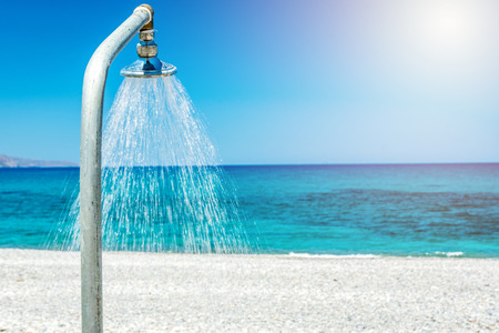 Ocean beach with shower  on the Crete in sunny dayの写真素材