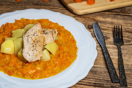 Steamed grated carrots with potatoes and grilled chicken meatの写真素材