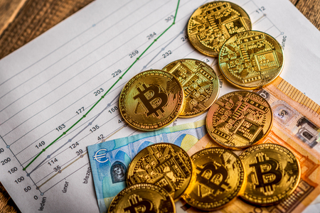 Golden  coins of crypto currency Bitcoin and Euro paper moneyの写真素材