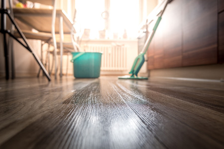 Wiping dirty wooden floor by wet wiper mop, houseworkの写真素材
