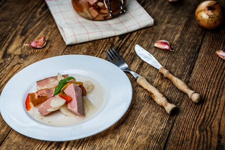 Czech pickled sausages with onion, pepper, vinegar on wood table. Czech name utopenci or utopenecの写真素材