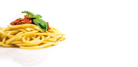 Italian pasta spaghetti bolognese with basil isolated on white backgroundの写真素材