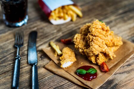 Fast food chicken breast strips and french friesの写真素材