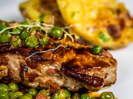 roasted veal entrecote with pea and gratin potatoes on wood tableの写真素材