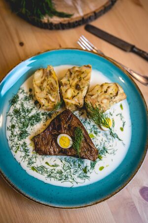 Beef brisket, dill sauce, quail eggs and dumpligの写真素材