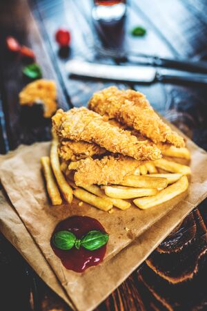 Fast food chicken breast strips and french friesの写真素材