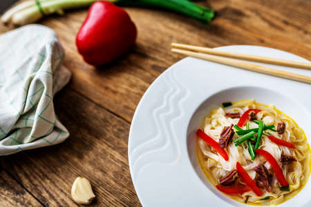 Vietnamese soup pho bo with asian noodles and beef meat on wooden tableの写真素材