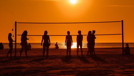 Silhouette volleyball game at sunset on beach generated by artificial intelligenceの素材