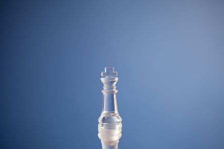King chess piece on a blue trend background, popular, trends in design and fashion