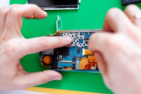 repair electronic equipment in service centre on a green backgroundの写真素材