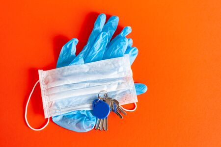 medical mask and gloves lie with keys on a background of lush lava color, Protection disease....