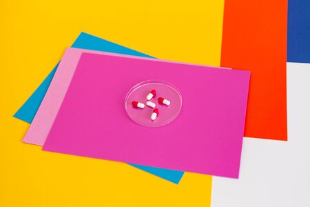 petri dish with pills on a colored backgroundの写真素材