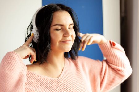 the girl in the headphones listens to music, concept of online media content service, online music