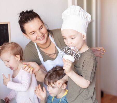 A young man wanting to eat the cookie dough on a whiskの写真素材