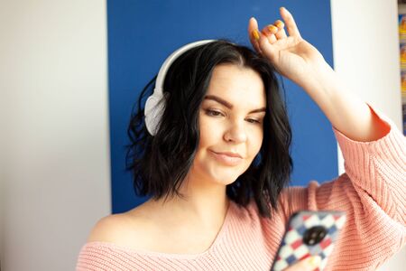 the girl in the headphones listens to music, concept of online media content service, online music