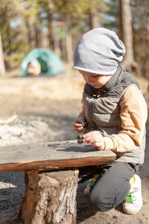 boy scout near a bench in the forestの写真素材