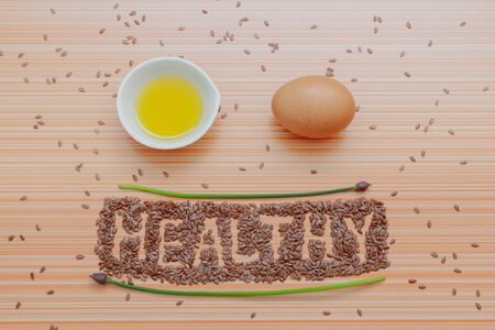 word healthy in chia seeds olive oil green stalk healthy food. Healthy fats concept. Top viewの写真素材