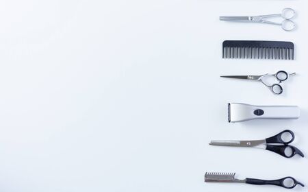 Composition with scissors and other hairdresser's accessories on white background, top view