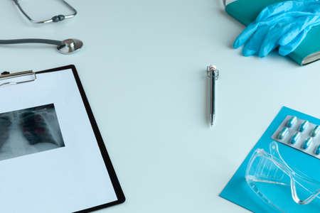Doctor general practitioner desk. Healthcare insurance concept. Table top view essential doctors equipmentの写真素材