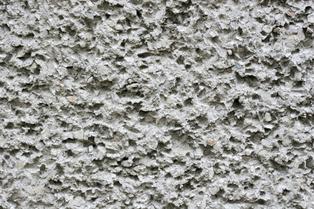 Concrete textured natural wall with stonesの写真素材