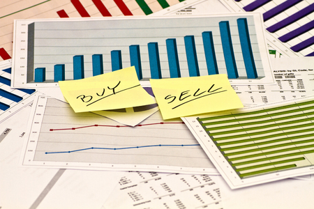Buy or Sell decision on charts and graphsの写真素材