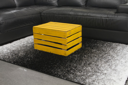 Yellow apple box as a coffee table on modern design home interior rugの写真素材