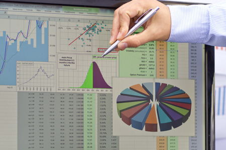 Stock market analyzing with pen on handの写真素材