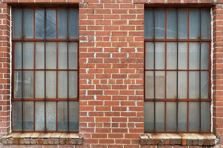 an old warehouse with windows and brick and glass
