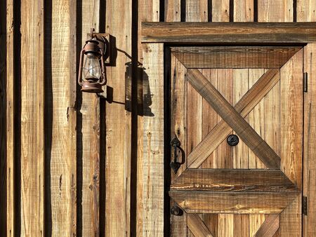 a ranch cabin with dutch door and rusty lantern